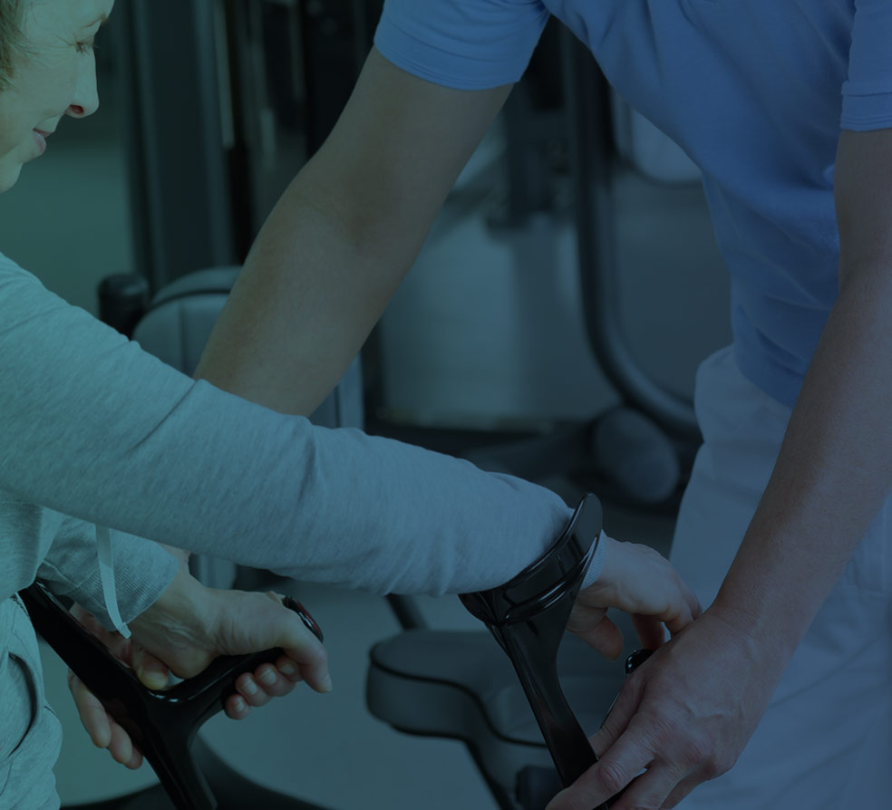 A therapist's hand offering steady support to a patient's hand